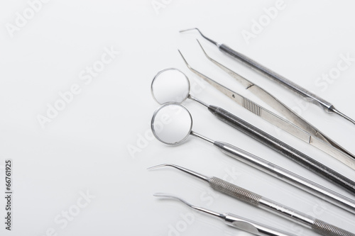 Set of Dental Tools In Line Together Laid Over White Surface