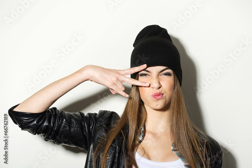 Hipster teenage girl with beanie hat posing photo