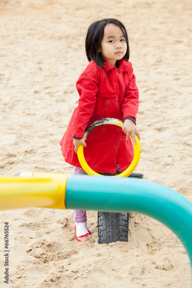 Asian child spending time on the playground Asian child spending time on the playground