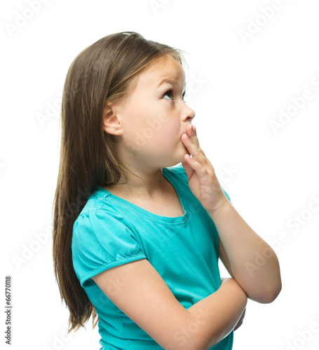 Cute girl is holding her face in astonishment
