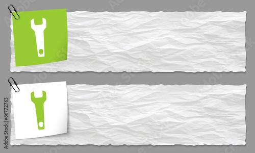 set of two banners with crumpled paper and spanner