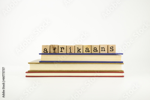 afrikaans language word on wood stamps and books photo