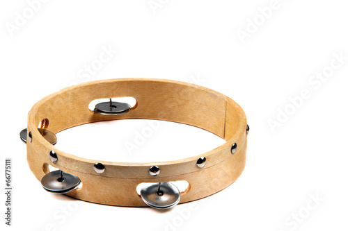 Isolated wooden tambourine with bell on white background photo