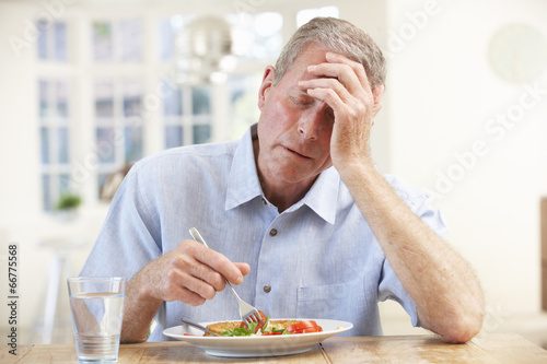 Tableau sur toile Sick older man trying to eat