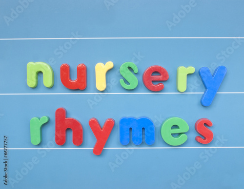 Quadro su tela Colorful magnetic letters spelling nursery rhymes on blue board