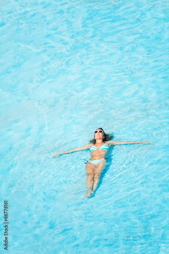 Woman with sunglasses swimming in the pool © Sergey Novikov