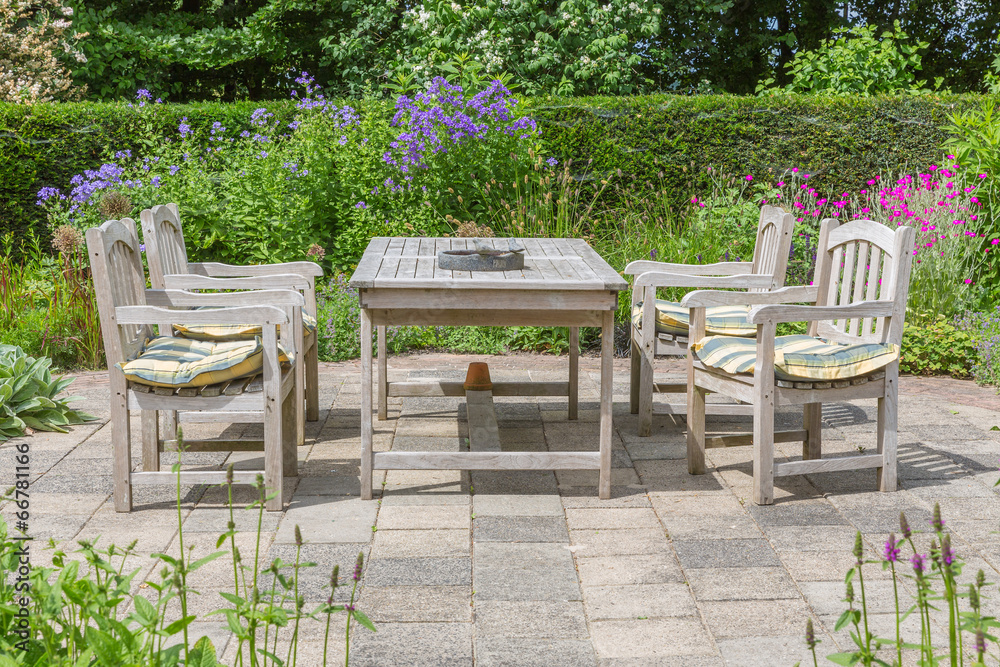 Wooden table and chairs in an ornamental garden Wooden table and chairs in an ornamental garden