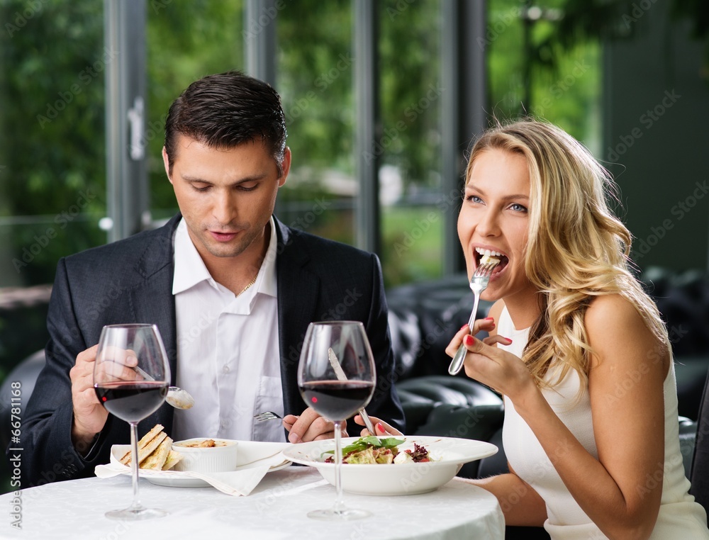 Couple eating in restaurant with a red wine Couple eating in restaurant with a red wine