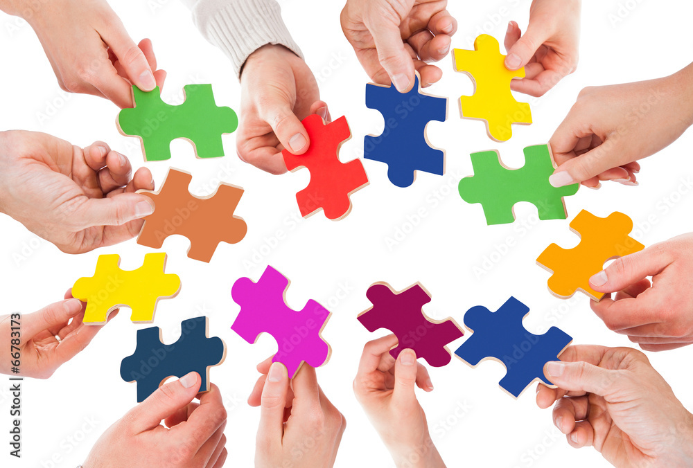 Business People Holding Colorful Jigsaw Pieces Business People Holding Colorful Jigsaw Pieces