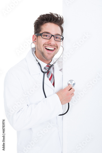 Doctor Examining Billboard With Stethoscope