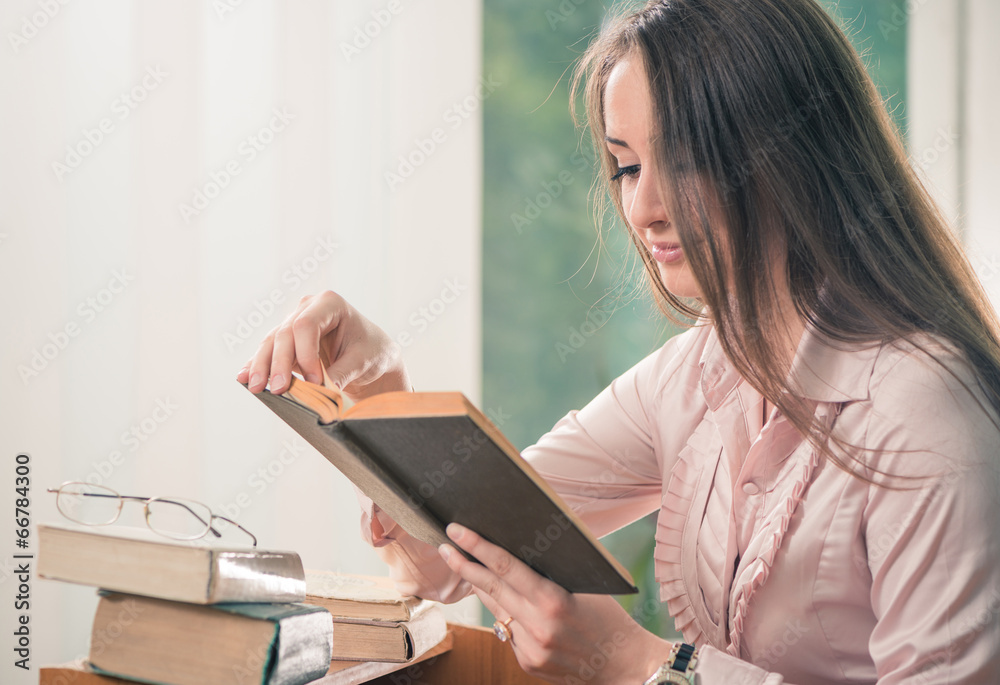 young female teacher reading book on a lesson young female teacher reading book on a lesson