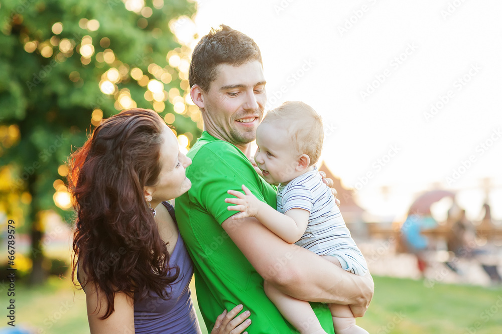 Fototapeta premium Young Attractive Parents and Child Portrait Outdoors