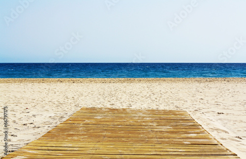 Wooden floor on empty beautiful beach