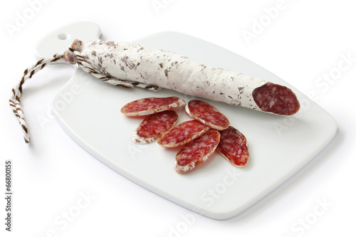 fuet galidad, spanish moldy salami on white cutting board photo