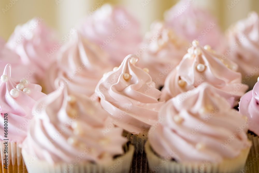 Pink cupcakes at white table  in high light style.