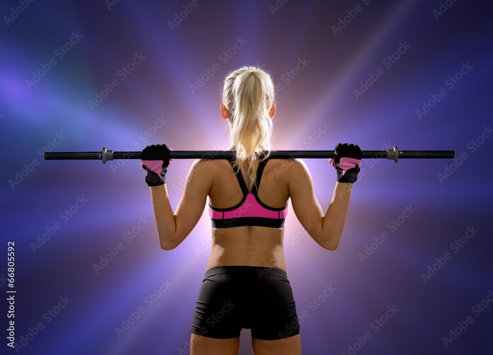 sporty woman exercising with barbell