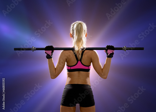 sporty woman exercising with barbell © Syda Productions