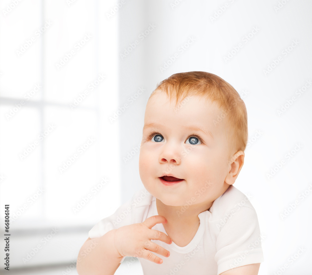smiling baby lying on floor and looking up