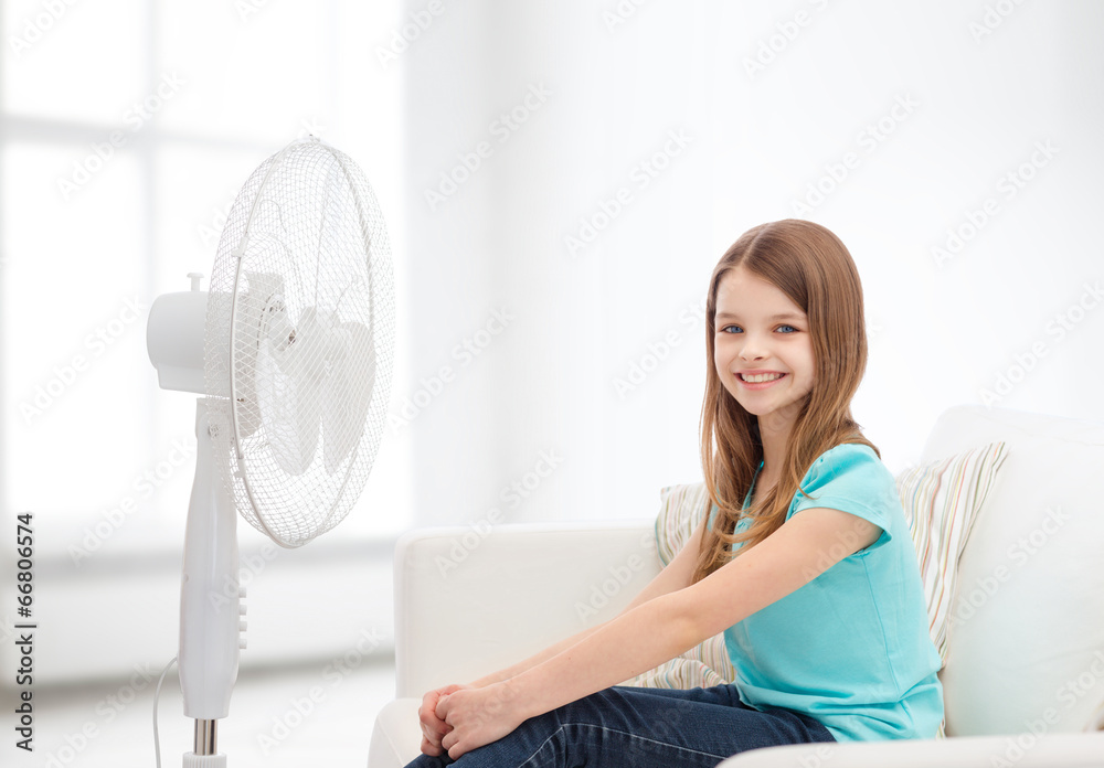 smiling little girl with big fan at home smiling little girl with big fan at home