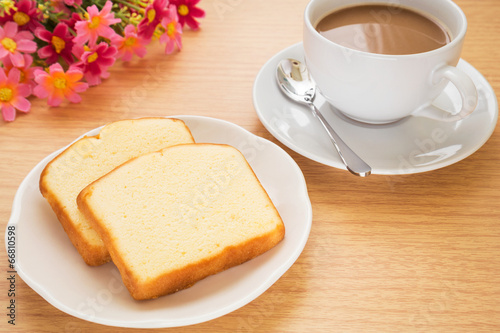 Butter cake sliced on plate and coffee cup