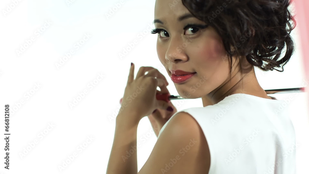 Portrait of asian woman with an umbrella posing in studio Portrait of asian woman with an umbrella posing in studio