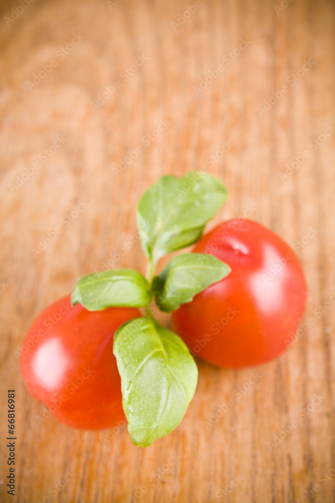 sweet little red tomatos and green basil sweet little red tomatos and green basil