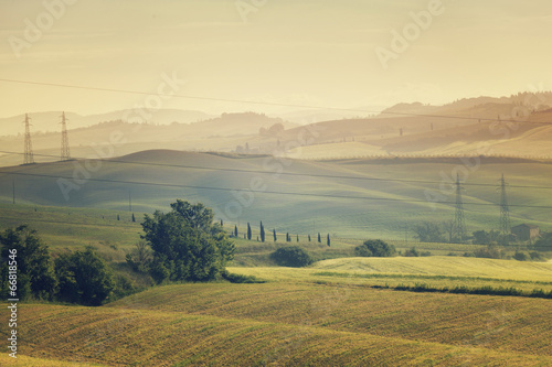 Fototapeta Naklejka Na Ścianę i Meble -  Morning landscape with the high voltage line, Tuscany, Italy