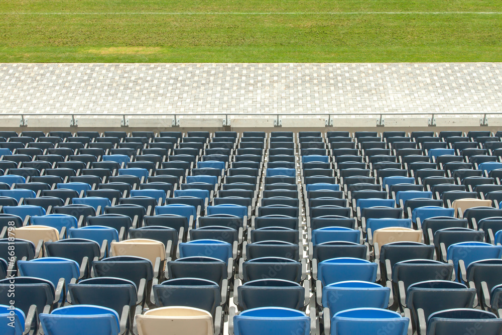 Naklejka premium Stadium seats and green grass