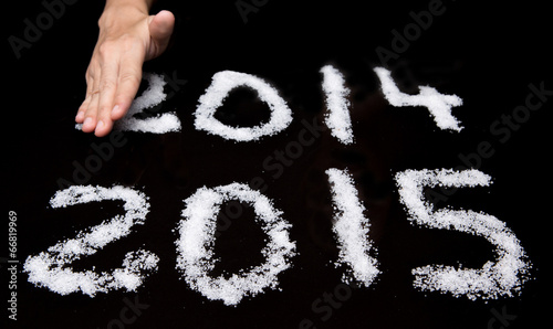 Tableau sur toile Female hands wiping Year 2014 leaving Year 2015