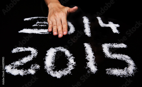 Tableau sur toile Female hands wiping Year 2014 leaving Year 2015
