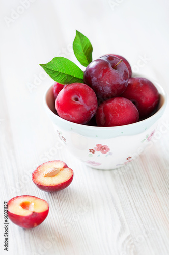 Fresh plums in a bowl, selective focus