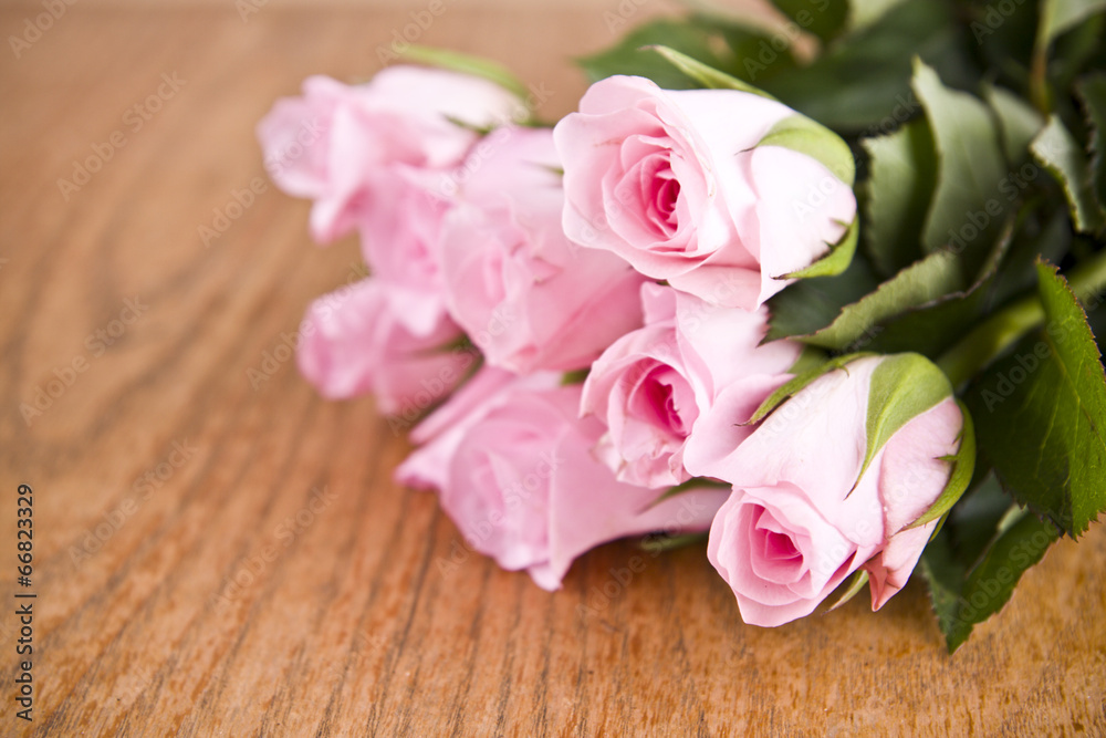 pink roses on wooden background pink roses on wooden background
