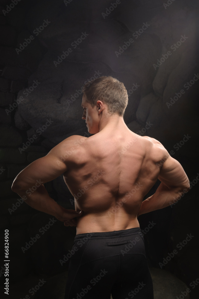 Fototapeta premium Athletic man on black backgrounds