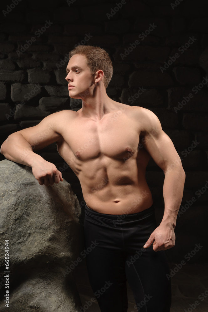 Fototapeta premium Athletic man on black backgrounds