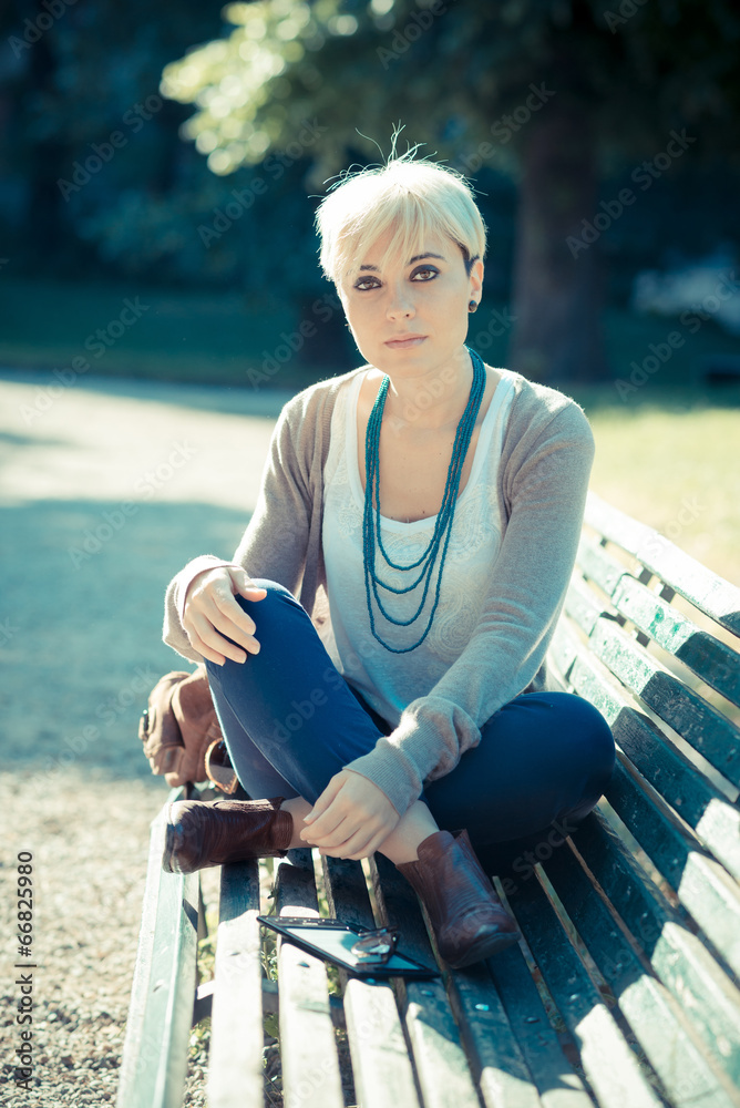 beautiful young blonde short hair hipster woman using tablet