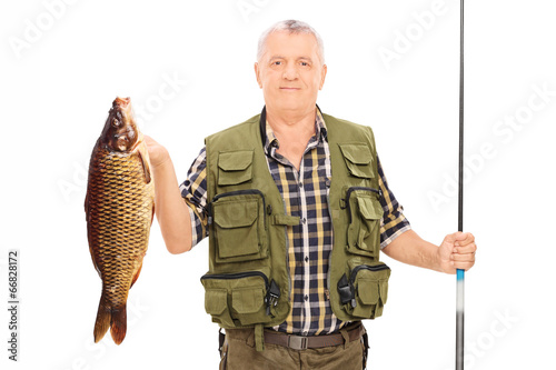 Fisherman holding a fish and a fishing rod
