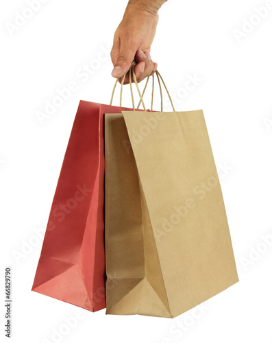 Man hand carries shopping bags on white background.