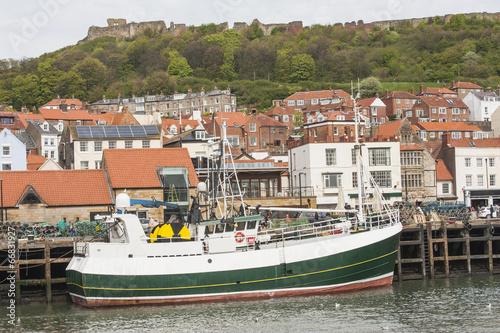 Fishing trawler in small town harbor