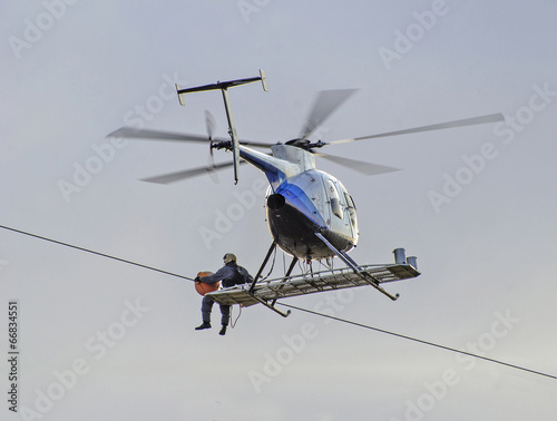 Fototapeta Naklejka Na Ścianę i Meble -  Repairing power gird from helicipter