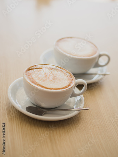 Two cups of cappuccino on the table