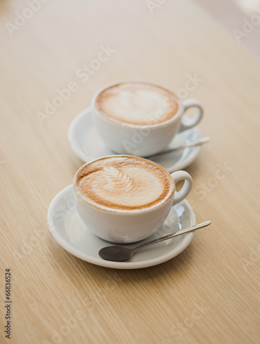 Two cups of cappuccino on the table