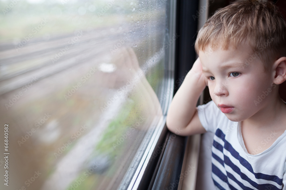 Boy looking out the window of train Boy looking out the window of train