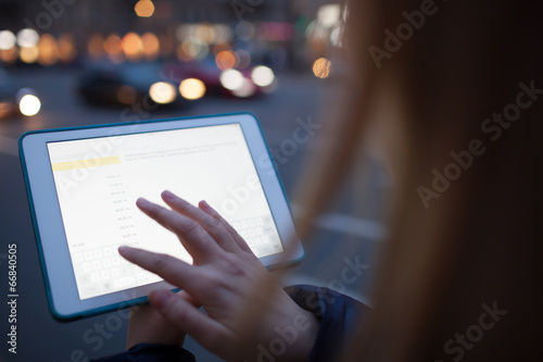 Woman touching tablet screen