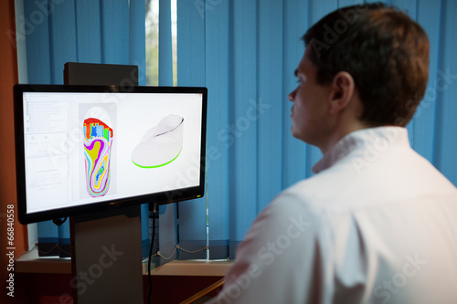 Orthopaedist at work with digital footstep model