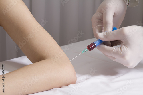 Closeup of doctor injecting platelet rich plasma to elbow