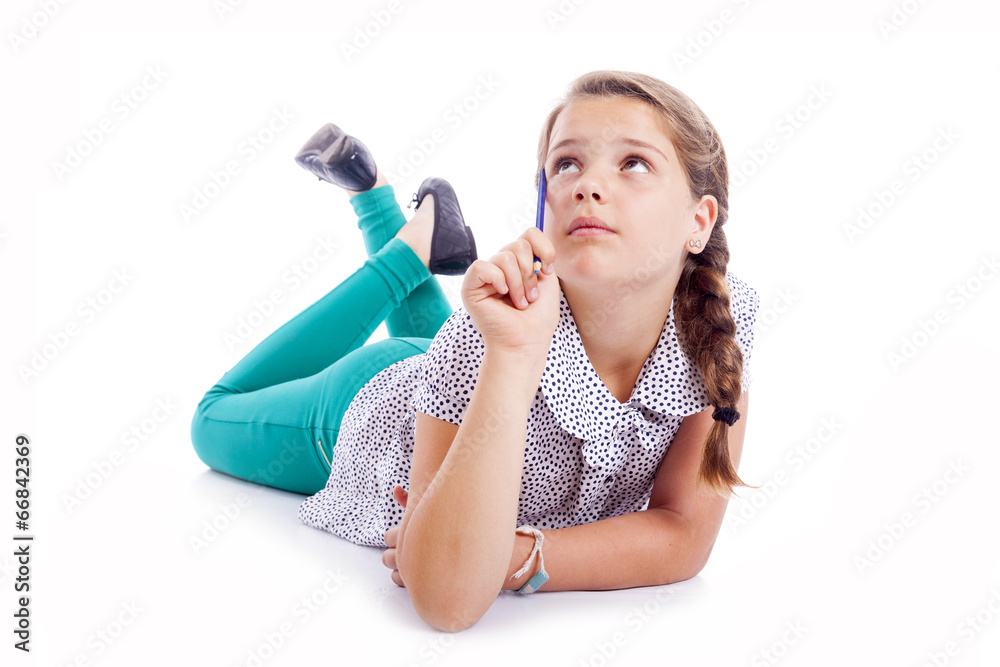 Pensive little girl looking up, isolated over white background