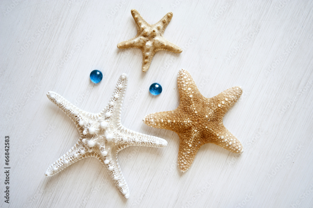 starfishes on a white wooden background with turquoise drops starfishes on a white wooden background with turquoise drops
