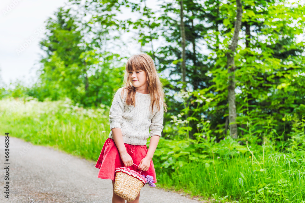 Portrait of a cute little girl with basket with flowers Portrait of a cute little girl with basket with flowers