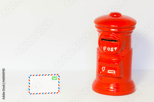 Pillar-box with a airmail on a floor