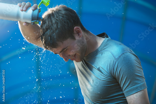 Athlete splashing pouring water head